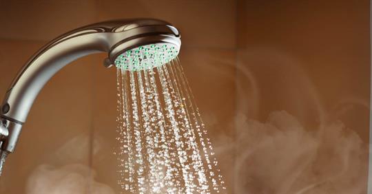 shower with flowing water and steam